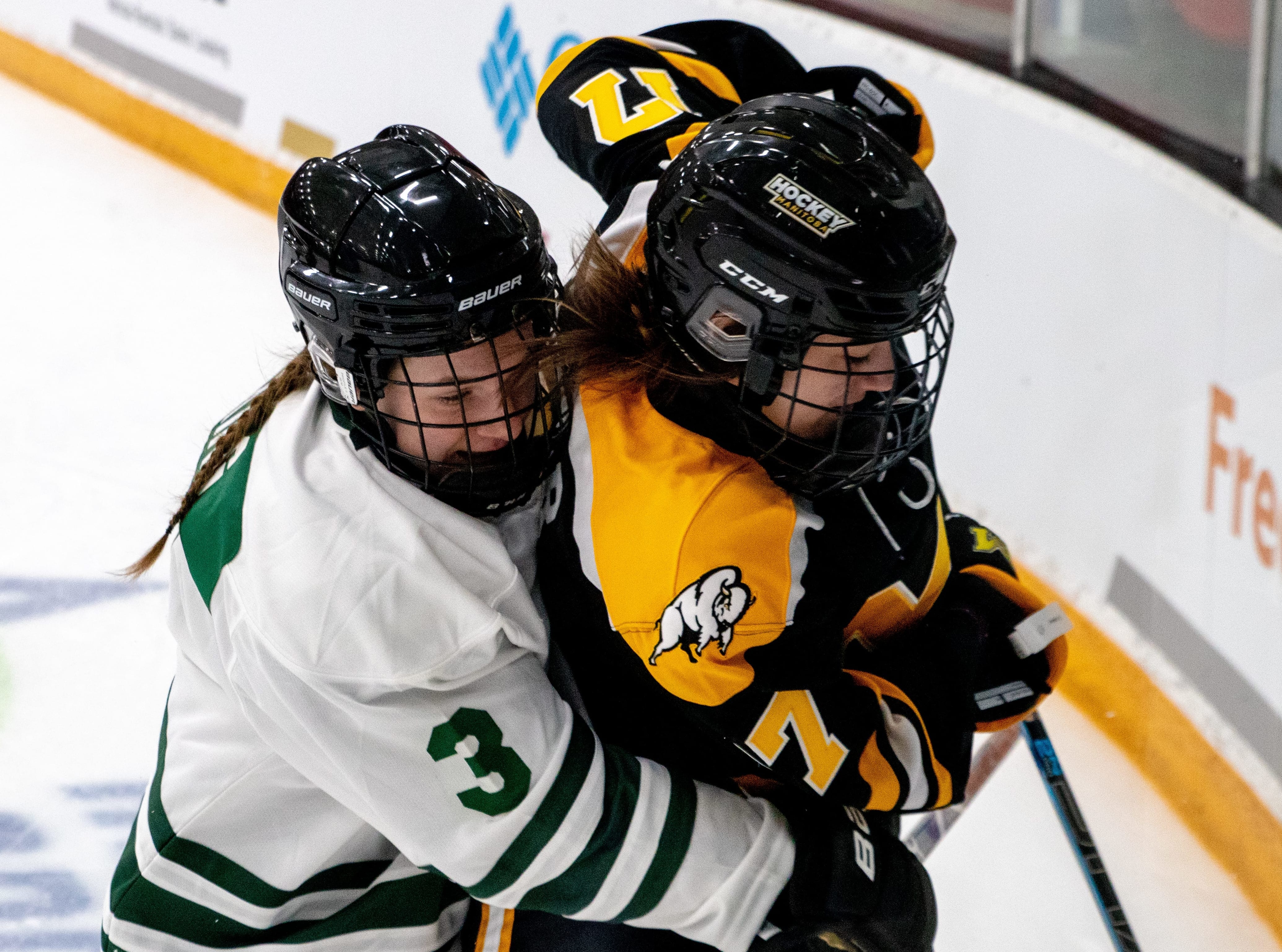 Annie King, formerly of Yellowknife and now playing in Saskatchewan, puts a Manitoba player in a bear hug during girls hockey action at the Canada Winter Games earlier this year. King will get the chance to wear the maple leaf as a member of Team Canada at the U-18 Women's World Hockey Championship in Slovakia next month after being named to the roster on Monday. Janine Johnsey/Canada Winter Games photo