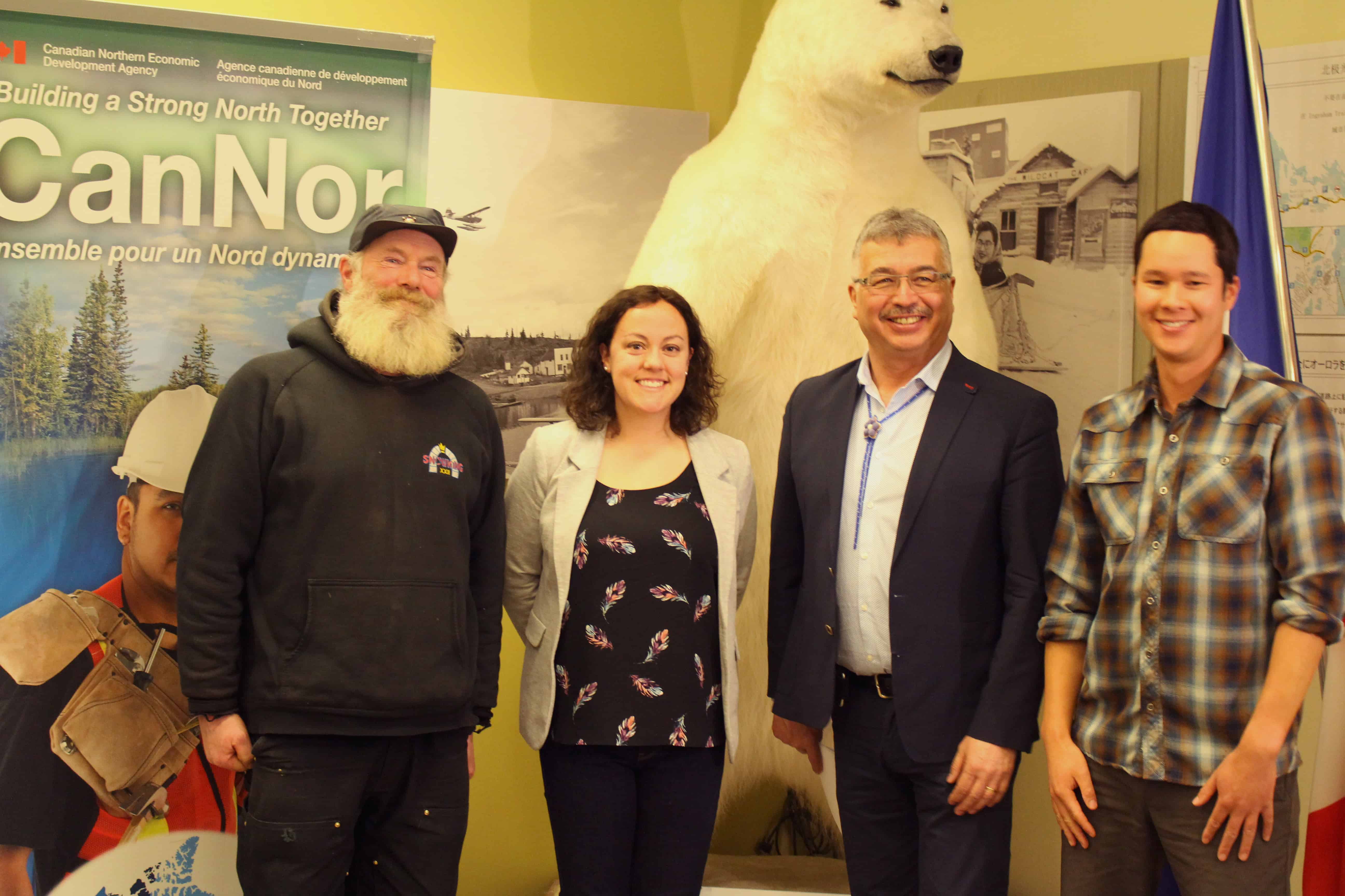 From the left, Snowking (Anthoiny Foliot), Mayor Rebecca Alty, MP Micheal McLeod and owner of Jackpine Paddle Adam Wong gather at the Visitor's Centre to announce $250,000 in funding toward three tourism initiatives in Yellowknife. Brett McGarry / NNSL Photo