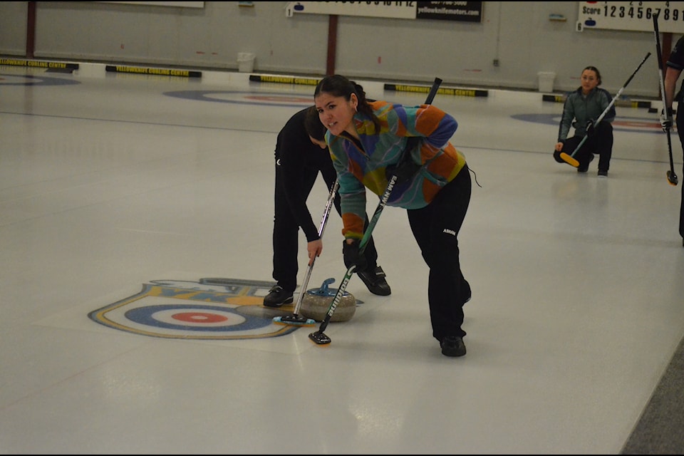 Tyanna Bain and Makayla Cook scrub the rock during action at the NWT Women's Curling Championship in Yellowknife on Sunday. James McCarthy/NNSL photo