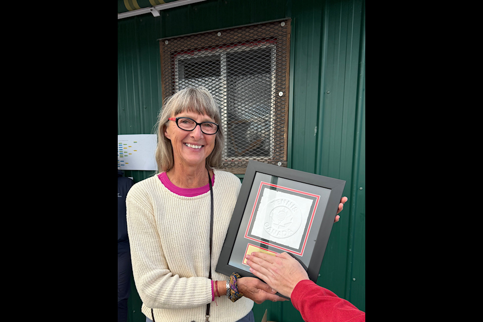 Joan Bevington and the plaque she received in honour of her Tennis Canada Distinguished Service Award.