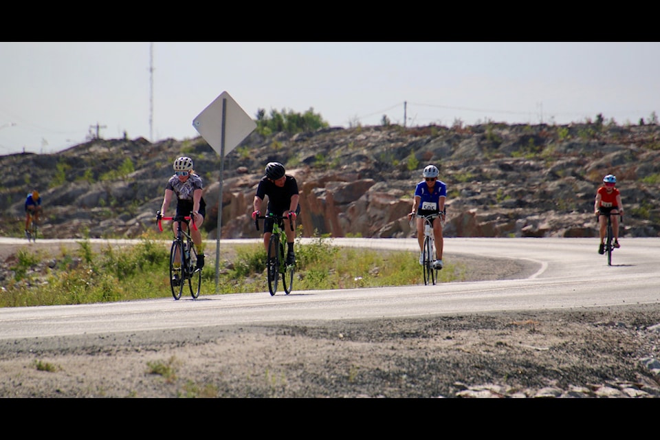 Cyclists in the Midnight Sun Triathlon make their way up Deh Cho Boulevard during last weekend’s event. Jill Westerman/NNSL photo