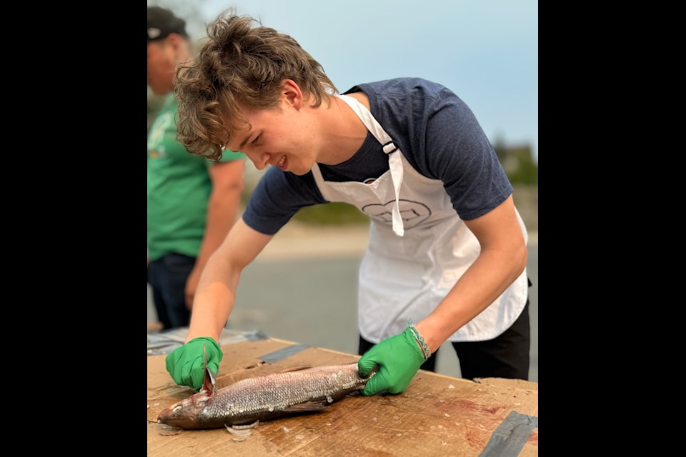 Jason Sealy, from Whitehorse, expertly scales a fish during the fish-cutting competition at the 2024 Indigenous Summer Games in Yellowknife in late June. 