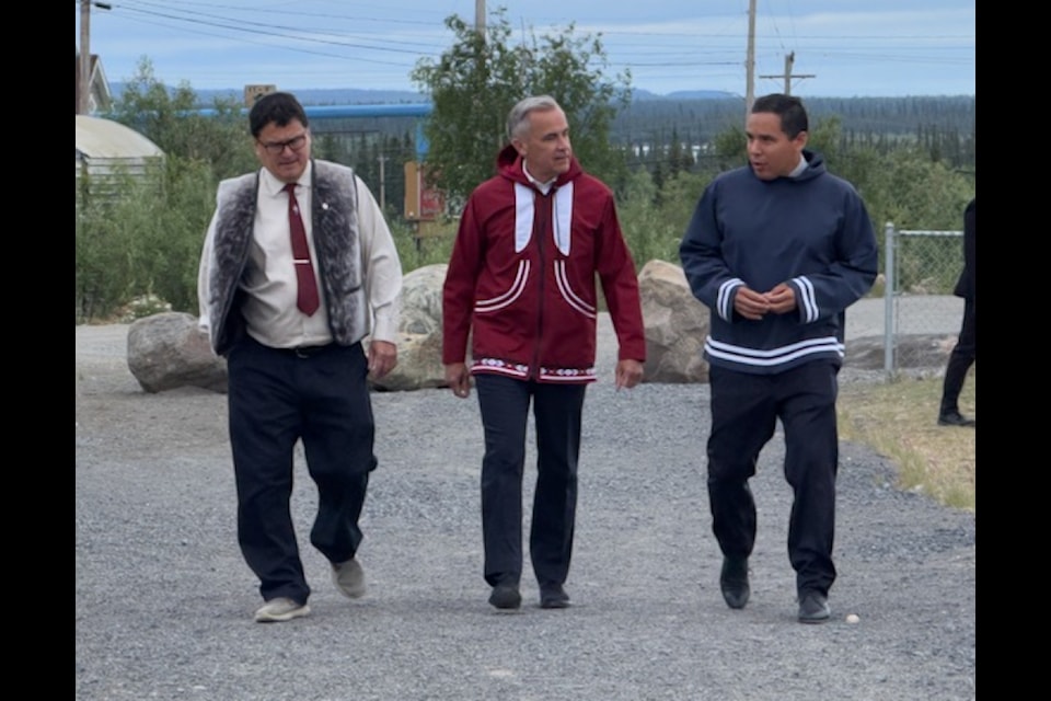Inuvialuit Regional Corporation chair Duane Ningaqsiq Smith, Prime Minister Mark Carney and Inuit Tapiriit Kanatami President Natan Obed talk while walking towards the Midnight Sun Complex in Inuvik on July 24. Photo courtesy of Inuvialuit Communications Society