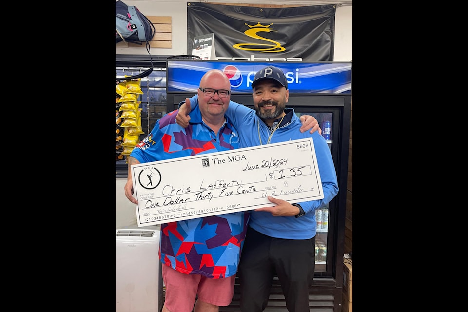 Shaun Morris, left, presents Chris Lafferty with the big cheque after Lafferty won The MGA at the Yellowknife Golf Club on June 20. Photo courtesy of Yellowknife MGA