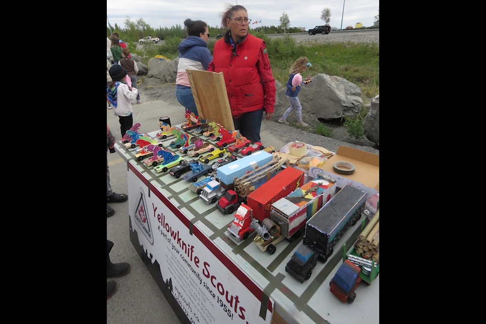 Amanda Smith, cub leader, stands over the Scouts table filled with creative cars and trucks made by Yellowknife Scouts during the annual Kar Rally Sunday. 