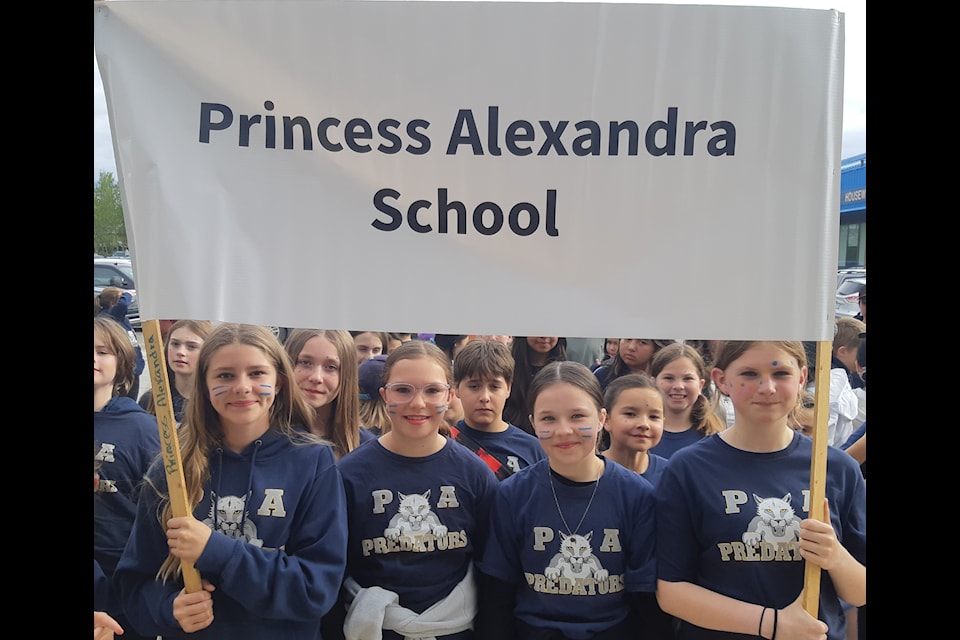 Princess Alexandra School had the honour of marching in first for the opening ceremony of the NWT Track and Field Championships in Hay River on Wednesday evening. The banner holders are, from left, Molly Campbell, Eleanor Bassett, Blakely Beck and Adele Russell.