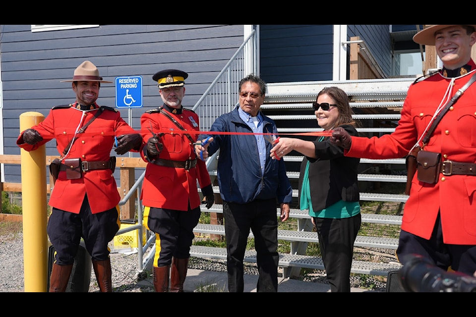 A ribbon cutting ceremony at the new Whati  detachment on June 23. From left, Cpl. Wes Neal, Chief Supt. Dyson Smith, Whati Chief Charlie Nitsiza, deputy minister of Justice Charlene Doolittle and Const. Jessy Mcintee. Photo courtesy 