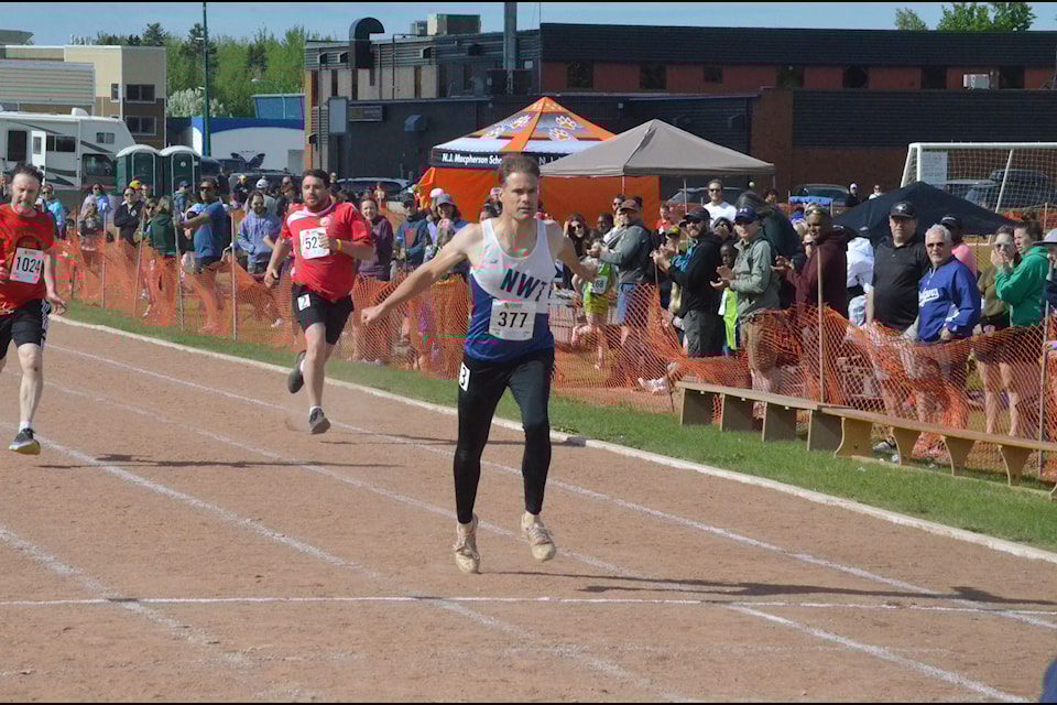 Eddy Smith of the Hay River Track Club makes sure he breaks the tape in the final of the senior men's 200-metre final on June 6. James McCarthy/NNSL photo