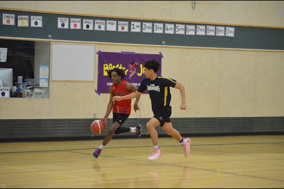 Fort Smith's Jaquan Blythe, left, tries to get past Behchoko's Dylan Nitsiza on the fast-break during the 18U boys Tier 3 final of the NWT Power Corporation Senior Cager basketball tournament in Yellowknife on March 9. James McCarthy/NNSL photo