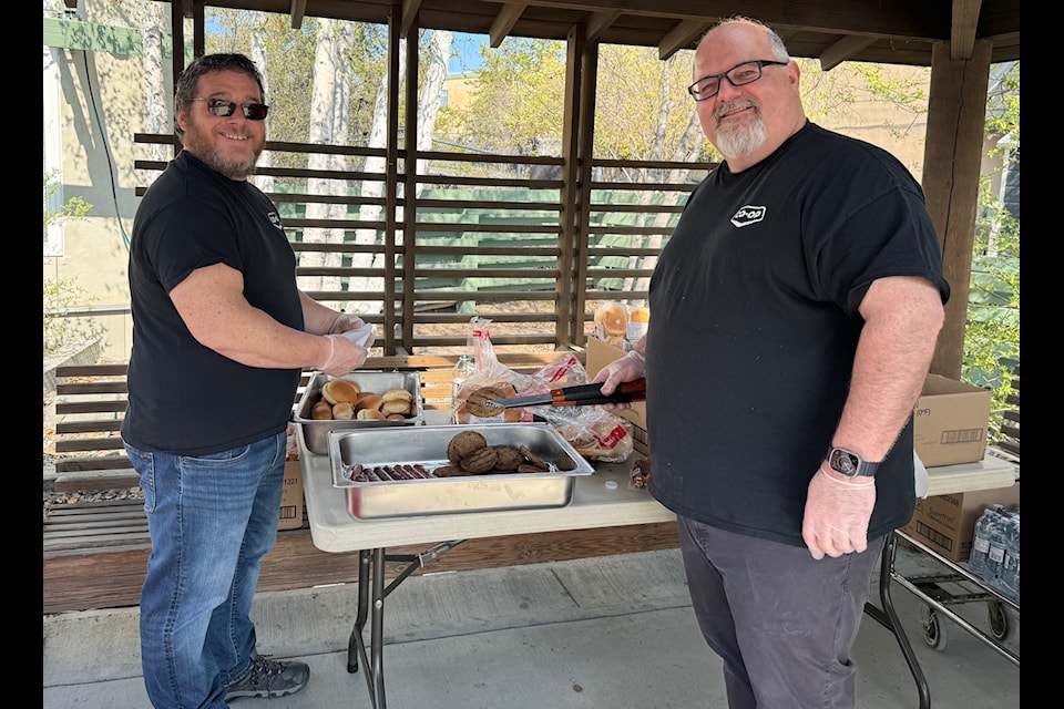 Cooking up a fine Co-op lunch for participants of the Yellowknife Alzheimer’s Walk on Saturday were, from left, Bill Walker, finance manager, and Justin Nelson, general manager of the Yellowknife Direct Charge Co-op grocery store.