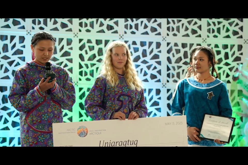 Brooke-Lyn Jade Bodnar, Indigo Taylor and Tamara Kaglik accept the Arctic Inspiration prize for Uniaraqtuq Youth Dog sledding club.