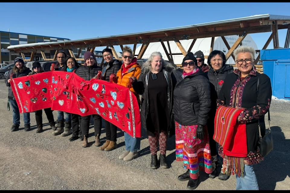 In Inuvik, people took to the streets in red to show solidarity. From left, Carly White, Alicia McDermott, Ishq Abraham, Celina Jerome, Lisa Keegan-Drennan, Rosemin Nathoo, Lindsay Wood, Eva Kratochvik, Ellie Adjun, Martina Israel, Debbie Gordon-Ruben and Eliza Firth.
