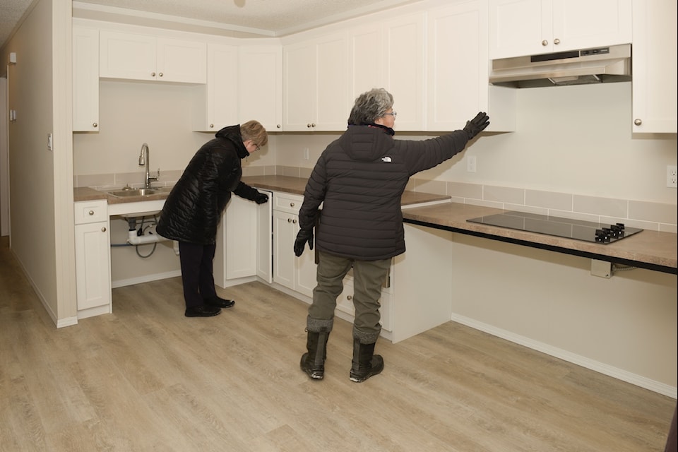 From left, GNWT Housing Minister Lucy Kuptana and Monfwi MLA Jane Weyallon Armstrong explore a kitchen in one of 10 new units headed to three Tlicho communities. Photo courtesy of Housing NWT