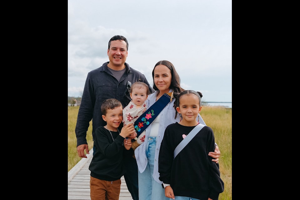 Karel Pekelsky, left, owner of Naka Electric, with his wife, Amanda Bradbury, and three children. 
