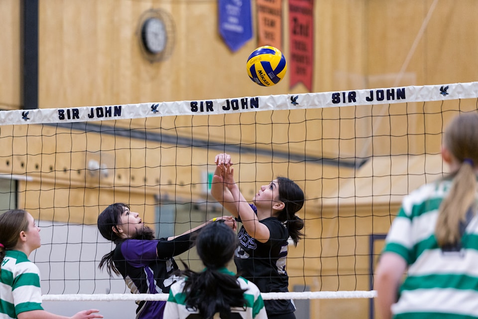 Kairyssa Jacobs, left, and Sydney Cayen try to keep the ball alive at the net. Photo courtesy of Thorsten Gohl