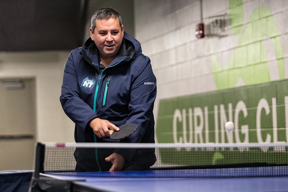 Municipal and Community Affairs Minister Vince McKay tries his hand at table tennis during a sport demonstration at the Aurora Ford Arena on Oct. 19. Photo courtesy of Thorsten Gohl