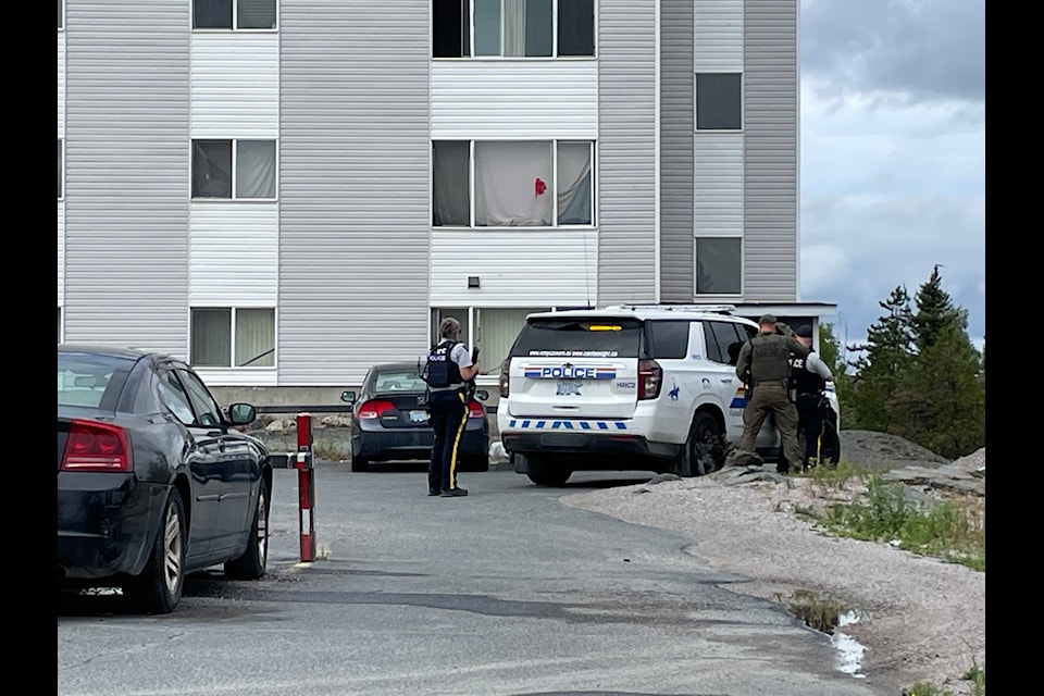Officers stand in front of Fort Gary Apartments, where an alleged armed person was inside the building, according to .