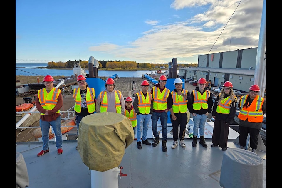 From left, Western Arctic Marine Training Centre graduates Quinn St. John, Seth Norn, Raymond Norn, Jacob Boucher, Wynner Josh Ramirez, Bradley Abel, Braiden Lafferty, Kyzer Hehn, Indigo Mielke, and Amanda Andre-Niditchie pose for a photo during a tour of the Hay River shipyard in fall 2024. All nine students are now qualified for jobs as deckhands on Canadian vessels. Photo courtesy of Cindy Drover-Davidson 