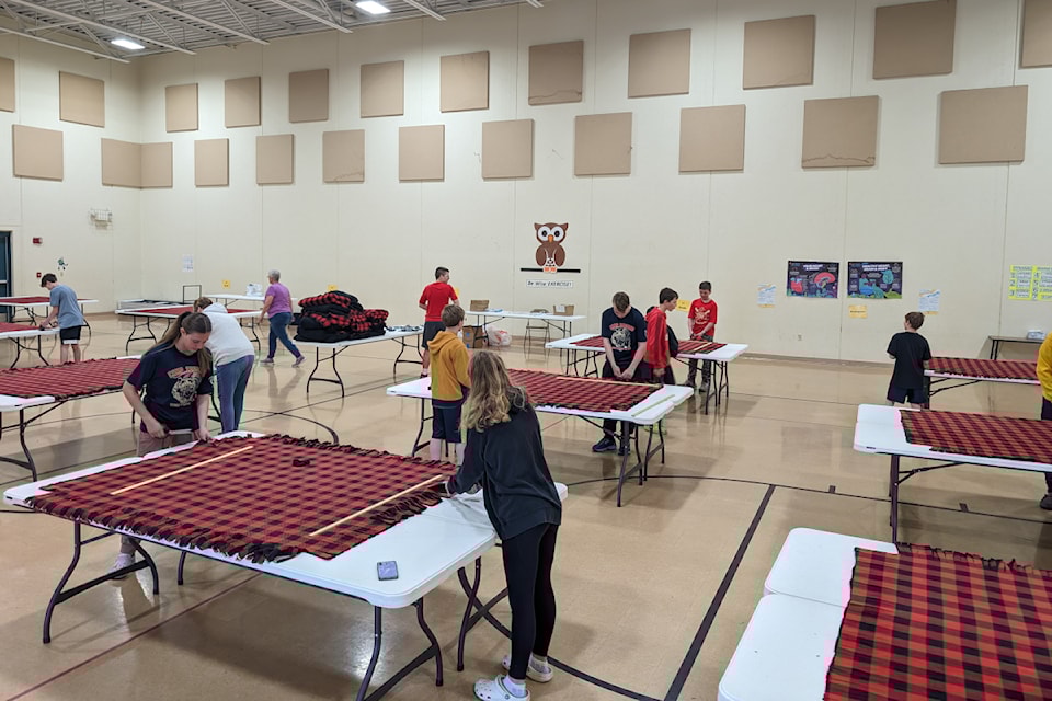 Volunteers in Wisconsin assemble more than 30 blankets to deliver to those in need in Inuvik.