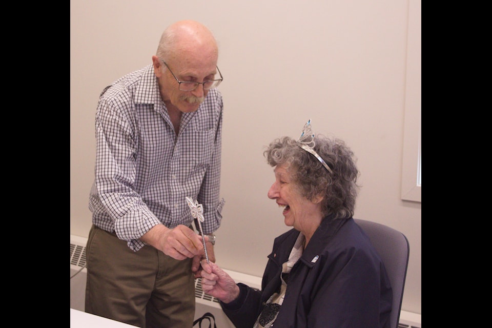 Town of Inuvik Mayor Clarence Wood bestows a crown and sceptre, declaring Margaret Miller 'Queen of the Volunteers' during a surprise farewell party at the Inuvik Welcoming Centre.