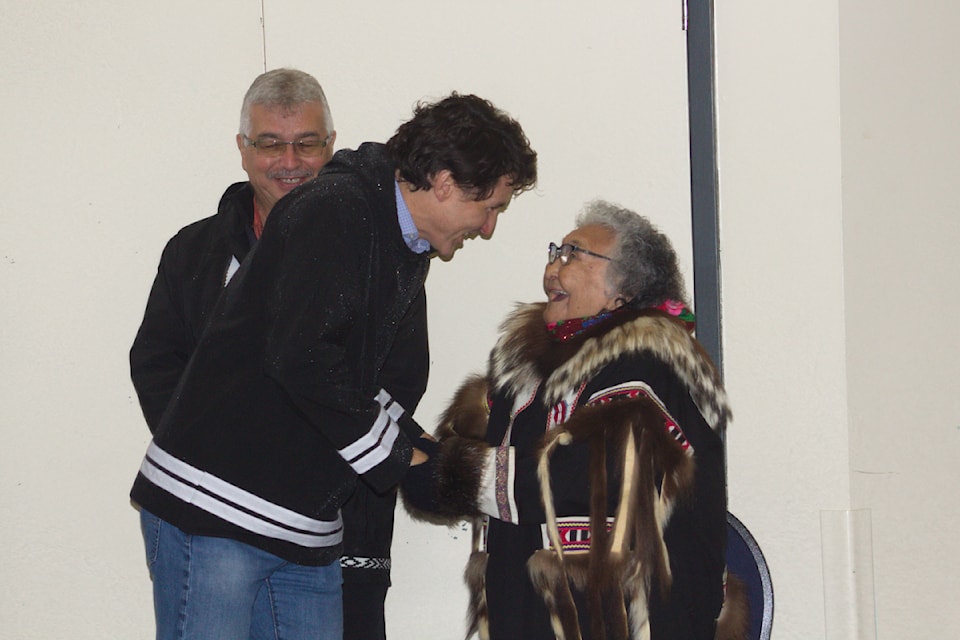 Elder Lilian Elias welcomes Prime Minister Justin Trudeau to the Midnight Sun Complex as NWT MP Michael McLeod looks on. Trudeau was in Inuvik on Sept. 30 to sign an accord between the Inuvialuit and Canada in regards to child care.