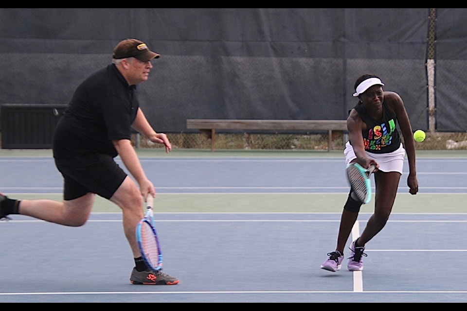 Alex Godfrey runs to provide backup for Anita Ogaa as she sends the ball over the net during the final tournament of the season at the Yellowknife Tennis Club last weekend. Jill Westerman/ϳԹ photo