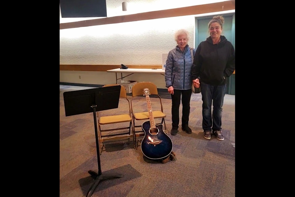 Teresa Watson, left, and Andrea Bettger, director of the Aurora Fiddle Society, stand next to an empty chair that used to be filled by Wally Watson. Jam sessions won't be the same without Wally again, writes columnist Nancy Vail. Photo courtesy of Andrea Bettger