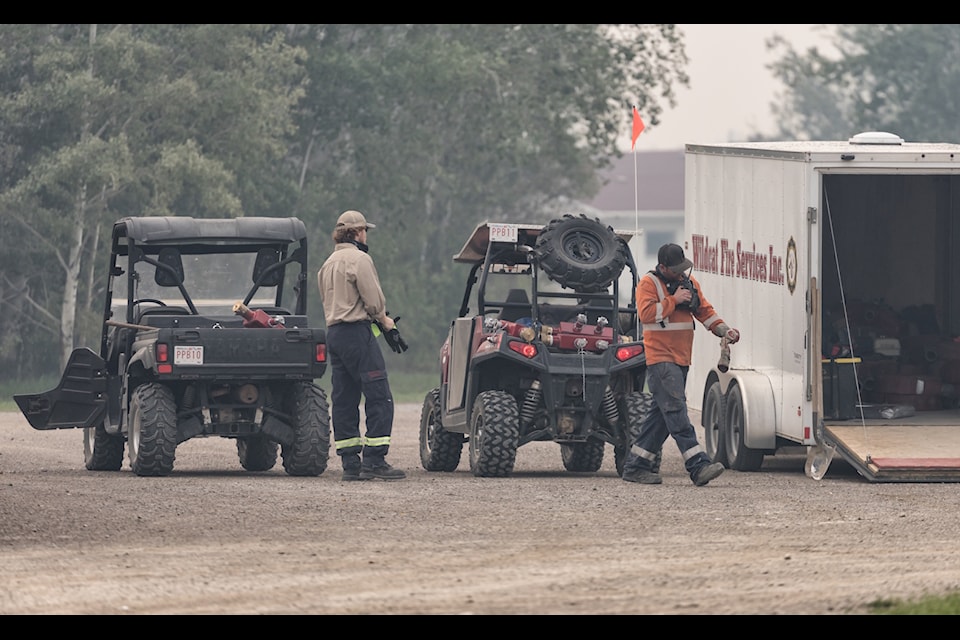Structure protection specialists are providing valuable service as wildfire crews and the incident management team focus on holding back the flames. Photo courtesy of Thorsten Gohl 