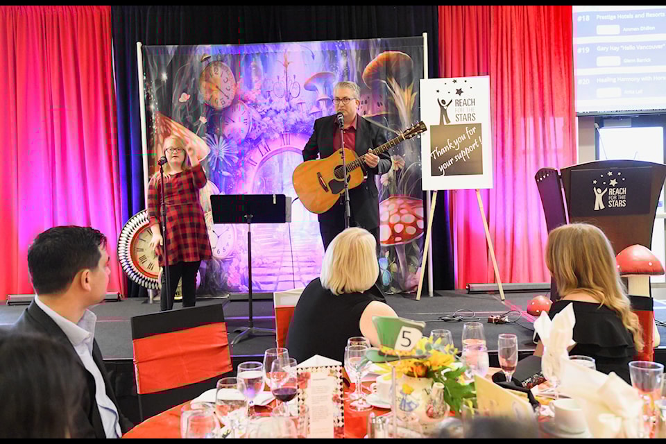 Tiana Schellenberg-Hamilton and dad Chris Hamilton offer a musical performance at Reach Child and Youth Development Society's Wishes and Wonder Gala held June 1, 2024.
