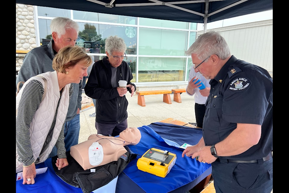 Using an approved anatomically-correct female-bodied training mannequin, paramedic public information officer Brian Twaites with BC Emergency Health Services showed members of the public how CPR is performed and where automated external defibrillator pads are placed during a demonstration event at the BC Ferries terminal in Tsawwassen on Thursday, June 26, 2025.