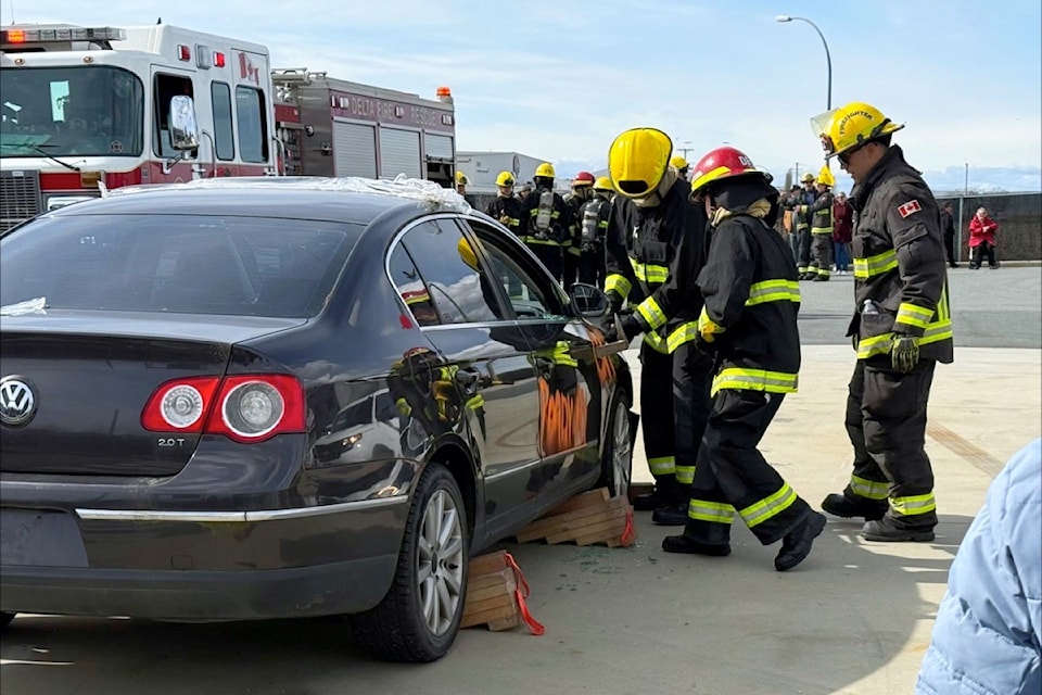 Students pry open a car door during a mock rescue at the graduation celebration for the 2025 Delta Fire Youth Academy on Friday, March 14.