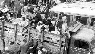 9409489_web1_52623675_Japanese-Internees-transported-in-open-bed-trucks