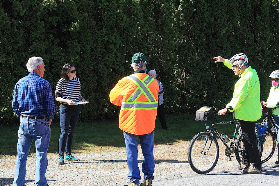 Frank Bucholtz (hand raised) explains to the City of Surrey’s Sheena Fisher (at left) April 15 why an old oak tree on 74 Avenue in Clayton should not be chopped down. (Photo: Malin Jordan)