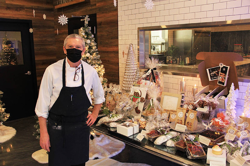 Pastry chef Eric Fernandez stands alongside some of his many creations at Popup Patisserie, a pop-up pastry shop on 176th Street that will be open until the end of December. (Photo: Malin Jordan)