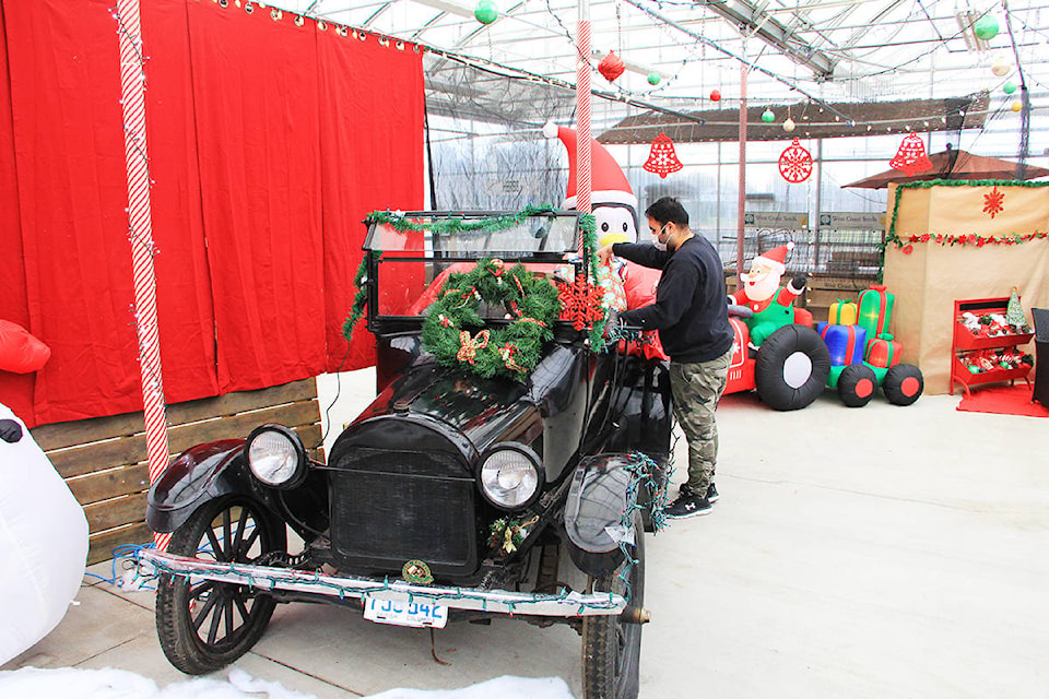 Gurbaz Singh, deli manager at the Cloverdale Country Market, arranges some gifts in the back of a vintage car. The car is part of the Cloverdale Country Market’s “December to Remember” picture taking area. The market is encouraging people to come down, snap some Christmas pics and share them on social media. (Photo: Malin Jordan)