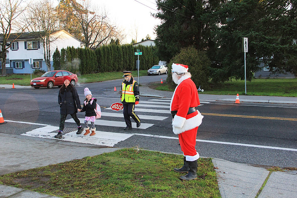 Ben “Santa” Cohen visits Ecole Martha Currie in Cloverdale Dec. 4. Santa wished everyone a socially-distanced Merry Christmas out in front of the school. (Photo: Malin Jordan)