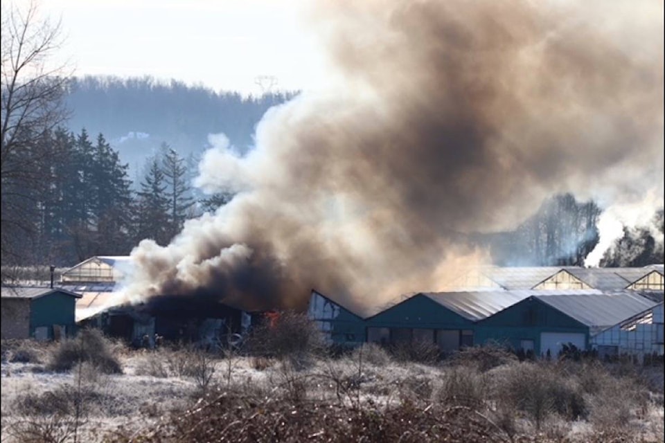 Smoke and flames engulf greenhouse on a rural South Surrey property Thursday (Dec. 24). (Shane MacKichan photo)