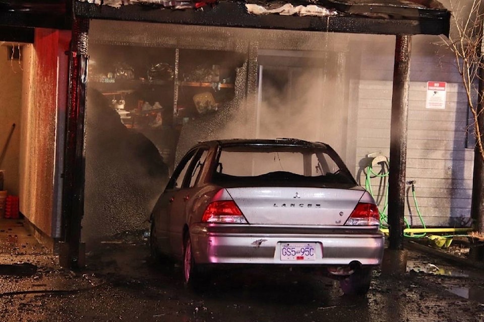 A car fire that spread to a townhouse brought Surrey fire crews to the 10700-block of 134 Street around 11:30 p.m. Monday (March 15). (Shane MacKichan photo)