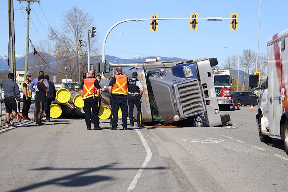 Traffic was tied up at the intersection of Scott and Old Yale Roads in North Surrey on Tuesday afternoon, after a semi truck hauling a load of pipes flipped while making a turn. (Shane MacKichan photos)