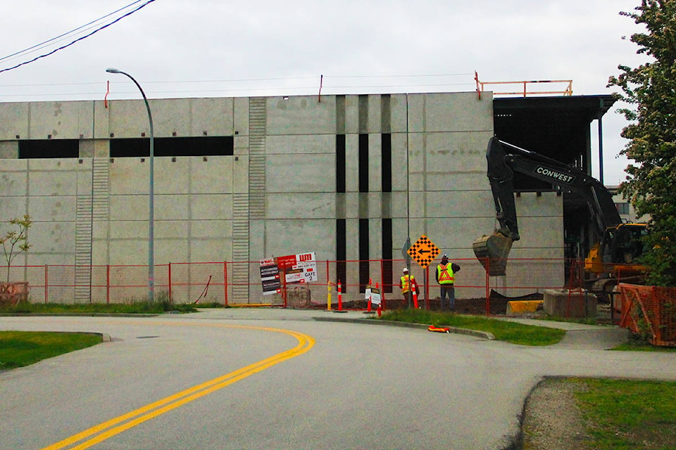 A construction crew works on the IntraUrban Crossroads building site in Cloverdale at 57 Avenue and 173 Street. Two of the three buildings on the 10-acre property are scheduled to open by the end of November. (Photo: Malin Jordan)