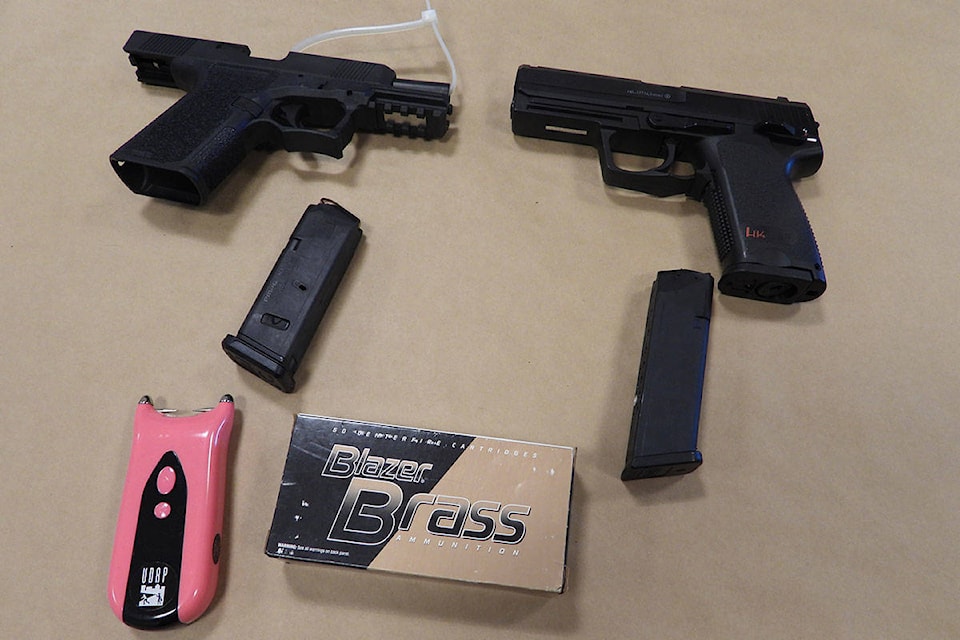 Surrey RCMP seized a number of guns that were allegedly connected to a Langley shop suspected of illegally selling cannabis. (RCMP handout)