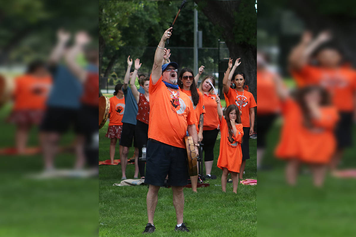 Gary Wong participates in a drum song at Kelownas City Park on June 4, 2021. The event honoured the lives of the 215 Indigenous children whose remains had recently been discovered in an unmarked grave on the former grounds of the Kamloops Indian Residential School. (Aaron Hemens/Capital News)