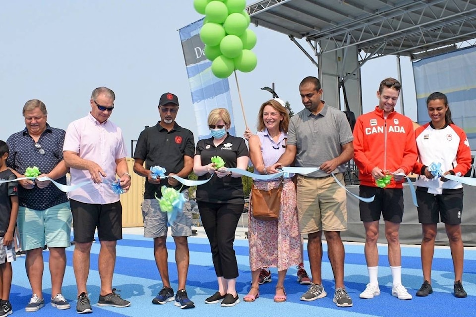 (from left) Delta parks, recreation and culture commission chair Don Sangster, Mayor George Harvie, school trustee Jesse Dosanjh, Delta MP and Minister of Employment, Workforce Development and Disability Inclusion Carla Qualtrough, Coun. Jeannie Kanakos, Delta North MLA and Minister of Jobs, Economic Recovery and Innovation Ravi Kahlon, Olympic rower Maxwell Lattimer and women’s national soccer team performance analyst Jasmine Mander cut the ribbon to officially open the new track facility at North Delta Secondary on Saturday, Aug. 14, 2021. (James Smith photo)