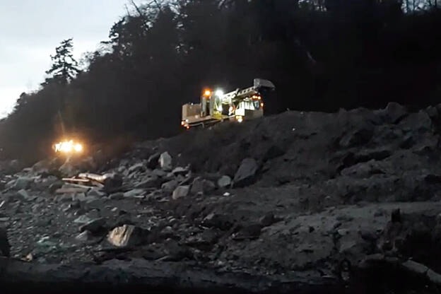BNSF crews move along the waterfront tracks in South Surrey, to tackle debris left across the tracks by the recent heavy rains. (Don Pitcairn YouTube video screenshot)