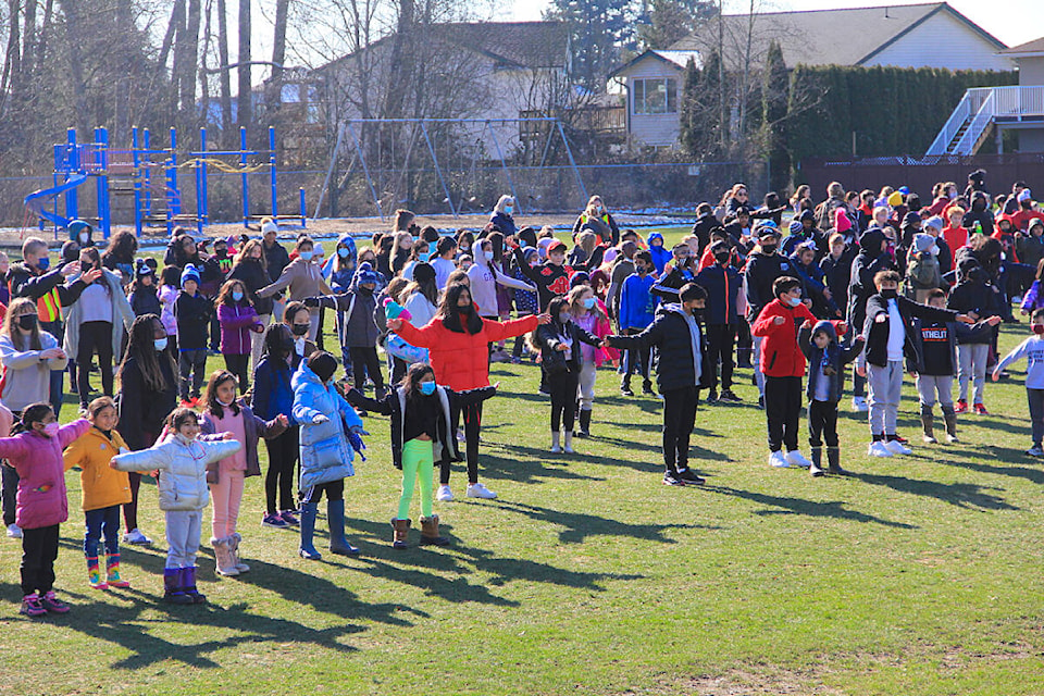 Staff and students from Sunrise Ridge Elementary warm up before a walk through their school neighbourhood in support of Coldest Night of the Year. The fundraising initiative supports the Cloverdale Community Kitchen. (Photo: Malin Jordan)
