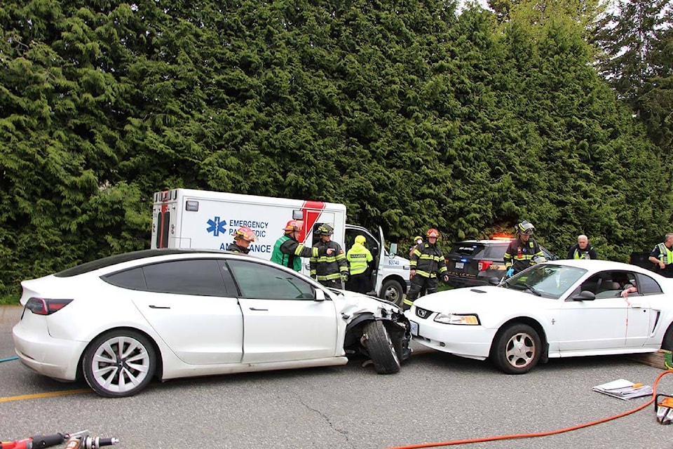 A mock impaired-driving crash between a Tesla and a Mustang took place Thursday (May 12) in front of W. J. Mouat Secondary in Abbotsford. (Vikki Hopes/Abbotsford News)