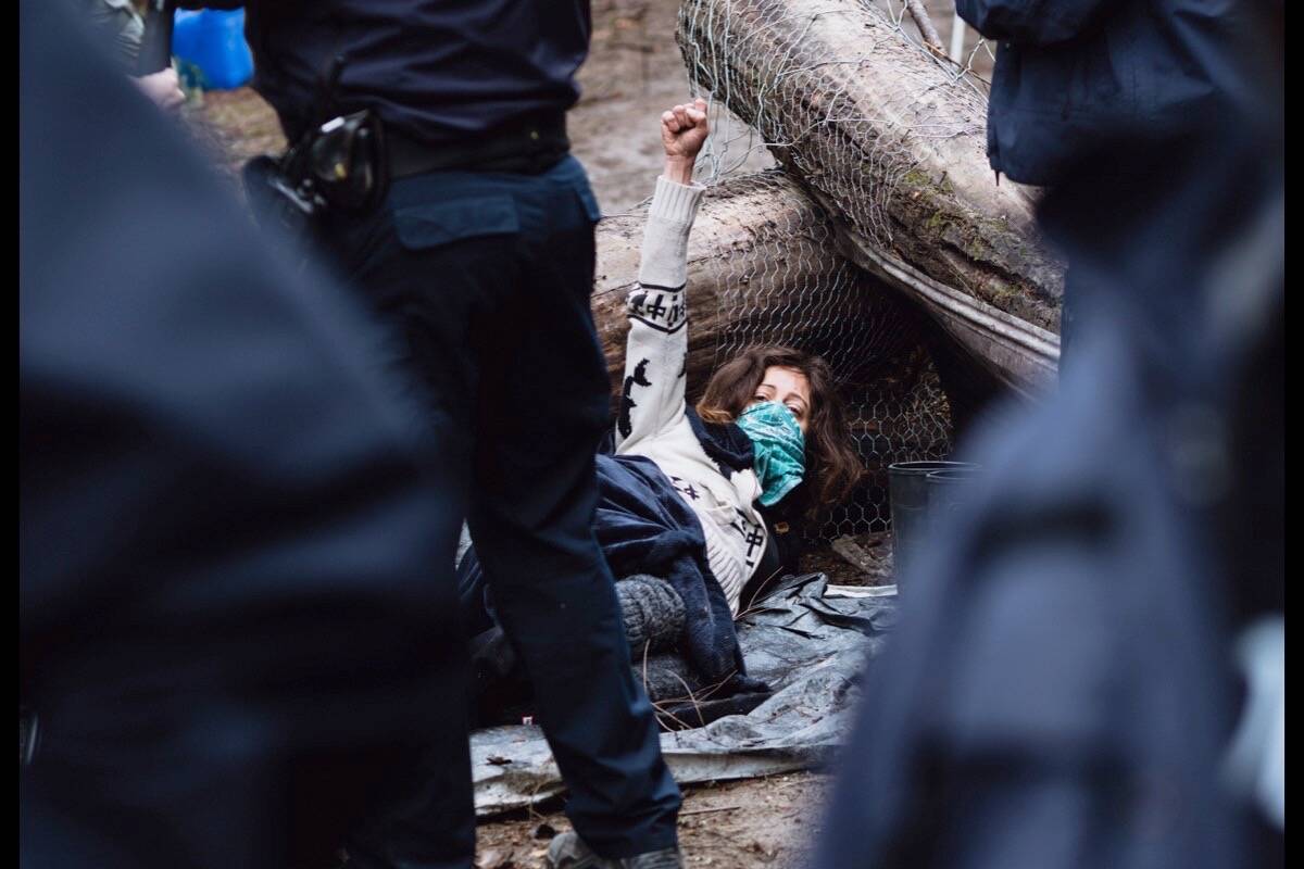 A protestor named Condor lies down after RCMP officers try to arrest him near Argenta, B.C., on May 17. Photo: Louis Bockner