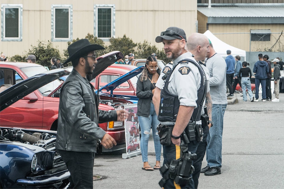 Hamed Almeshkhas talks to a Surrey Mountie at the Asphalt Angels Charity Car Show May 28. The RCMP came out to support the charity event which was put on by RCS Autohaus, a car rally club. All funds raised went to support Cloverdale’s Fraser Valley Regional Food Bank. (Photo submitted: Cloverdale Community Kitchen)