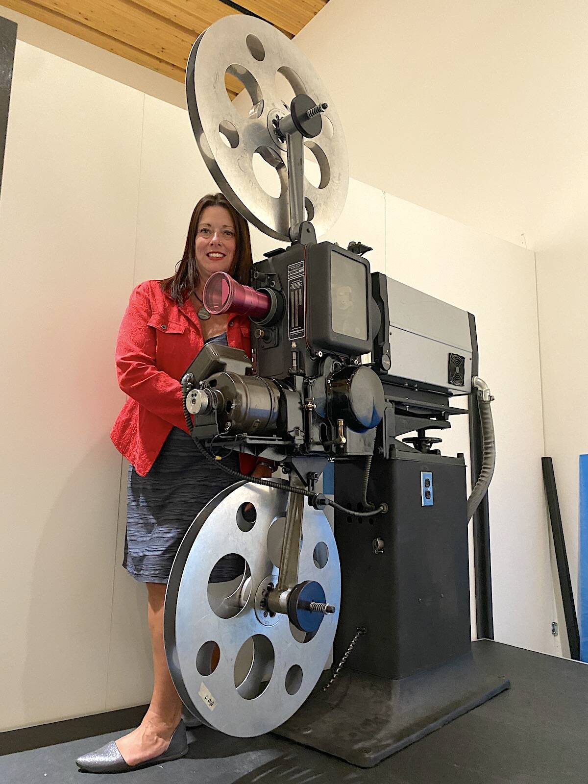 Colleen Sharpe, curator of exhibits at the Museum of Surrey, with a projector used at the old Clova Theatre in Cloverdale. The projector is showcased in the new Surrey on Screen exhibit at the museum. (Photo: Tom Zillich)