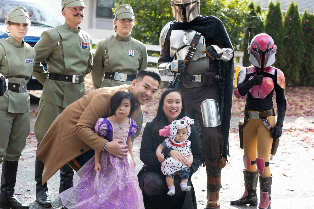 Xavier, Alex, 3, Nate, 6m, and Carmela Yee pose for a photo with mandalorians, and other people from Star Wars at the Treat Accessibility event for children with disabilities in Surrey on Saturday, Oct. 22, 2022. (Photo: Anna Burns)